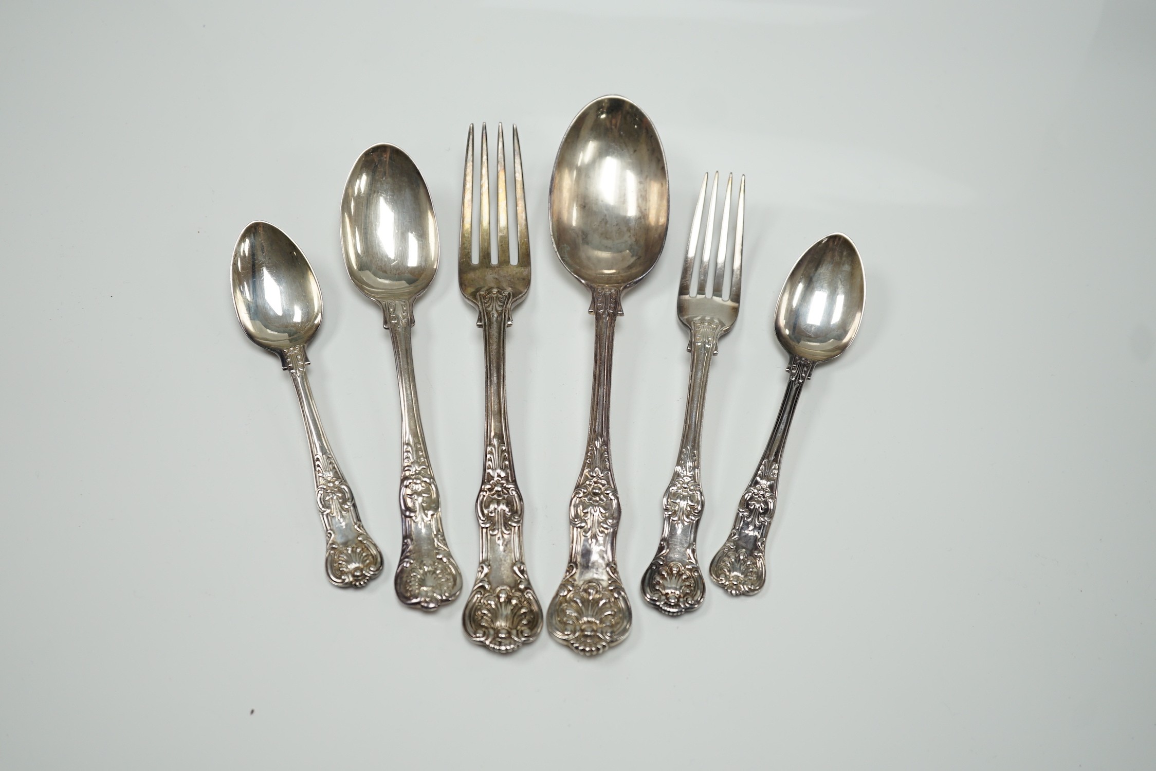A harlequin part canteen of 19th century and later silver Queen's pattern cutlery, various dates and makers including a set of nine table forks, by William Robert Smily, London, 1855, a set of eight table spoons, Wakely